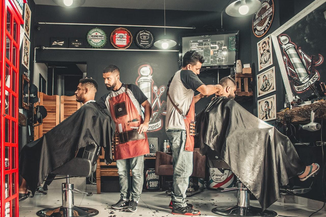 men sitting in salon having a haircut